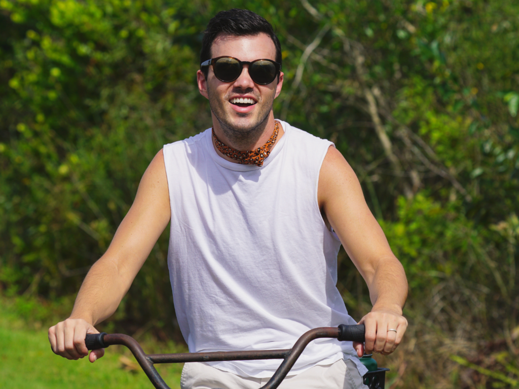 young man wearing sunglasses biking Shark Valley bike trail Everglades National park