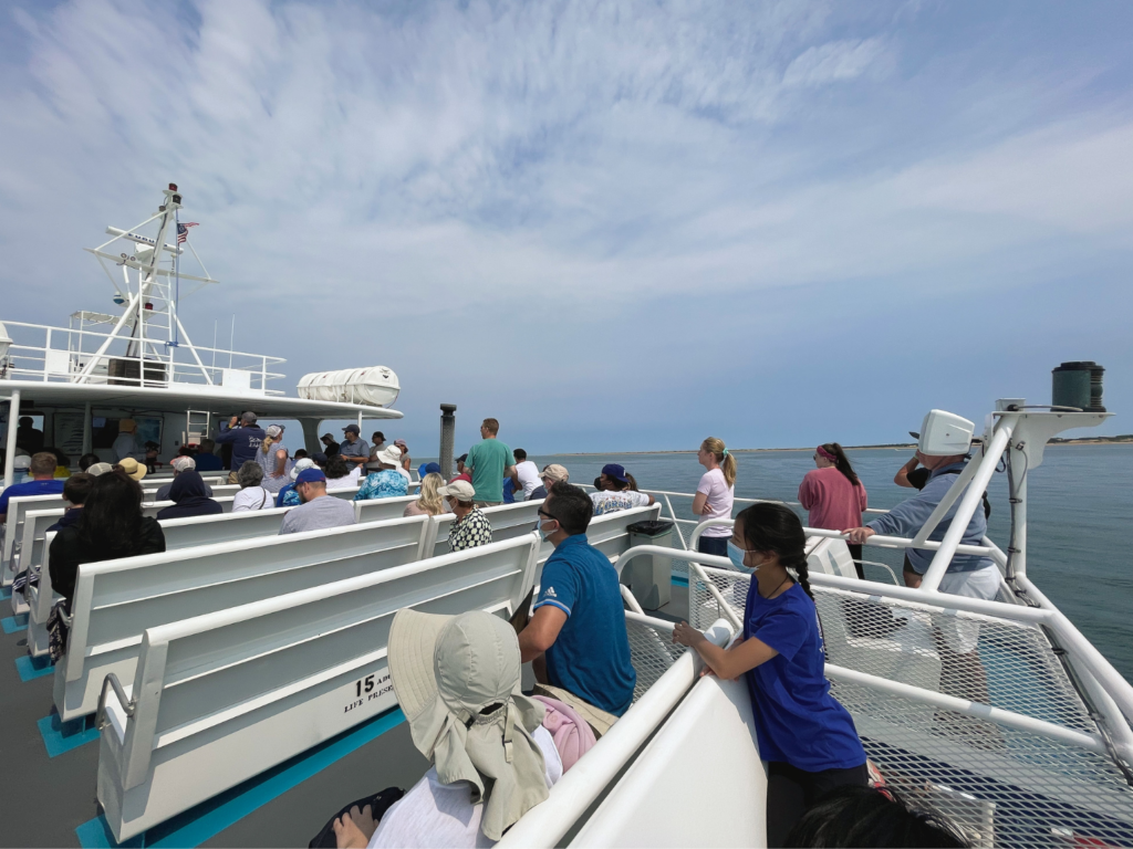 guests learning about whales on an ethical whale watching tour