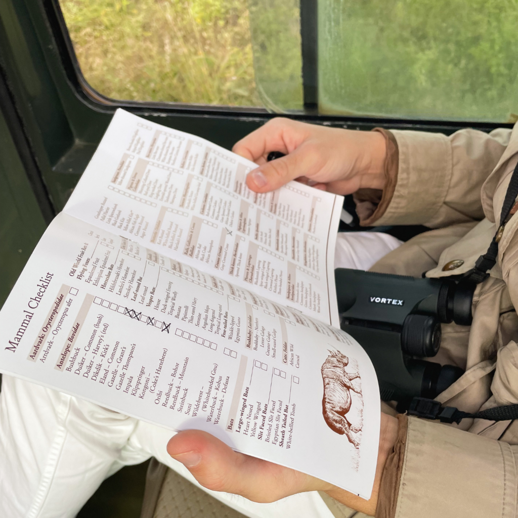 man holding a safari animal checklist