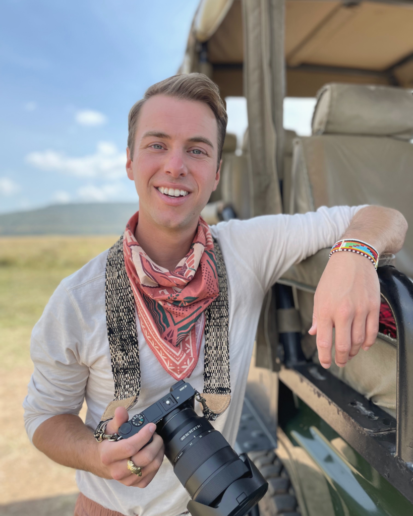 Milo next to a safari jeep Masai Mara National Reserve.